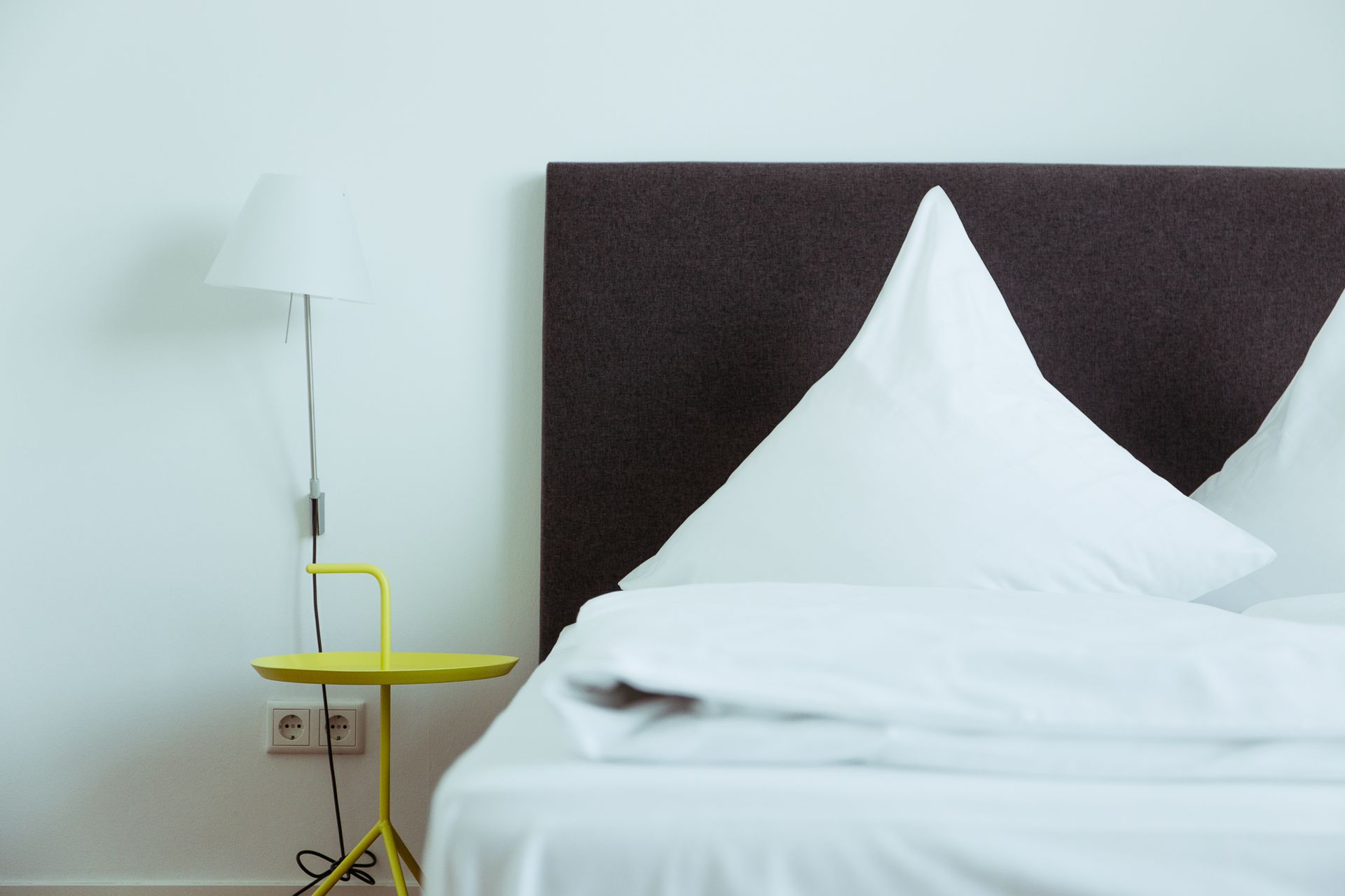 Bett mit Nachttisch im Doppelzimmer